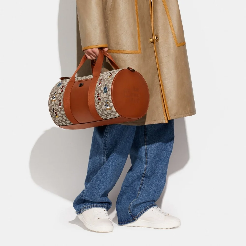 DISNEY X COACH DUFFLE BAG - SIGNATURE TEXTILE JACQUARD MICKEY MOUSE AND FRIENDS